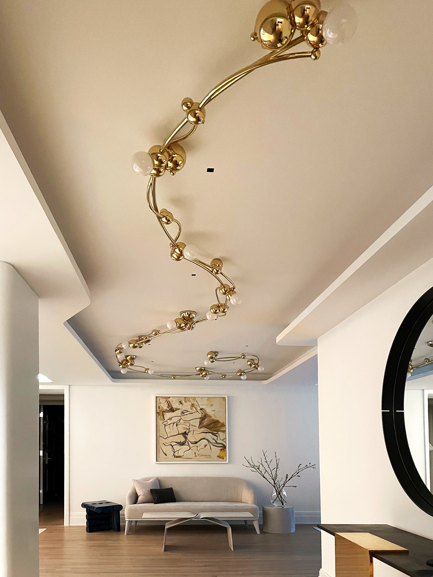 Tonal Palette on Park Entryway featuring a light fixture by Rosie Li, custom sofa by Pembrooke...