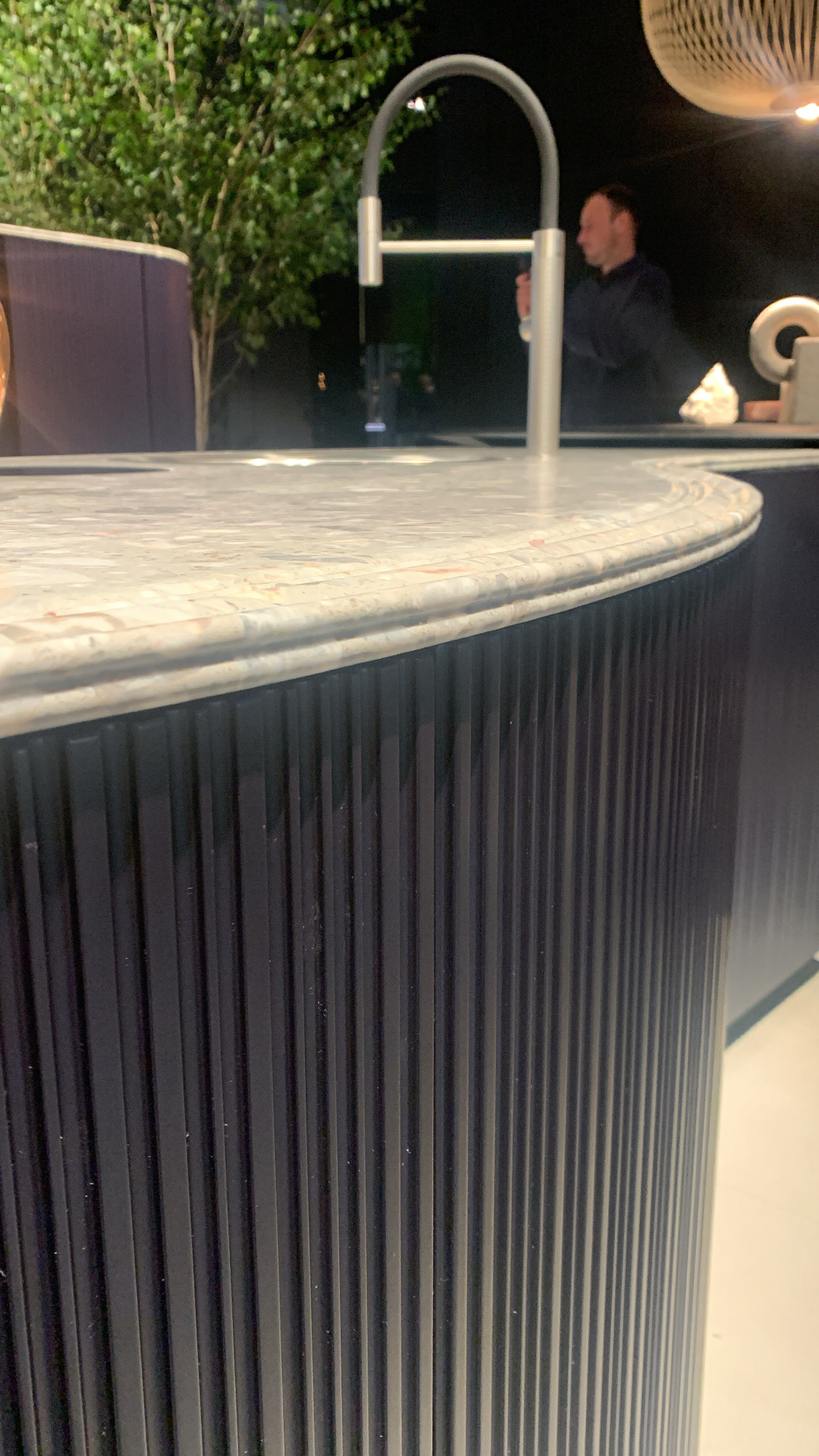 Cesar Fluted Wood at Salone del Mobile 2022 in Milan. Modern white tabletop with black wood sided.