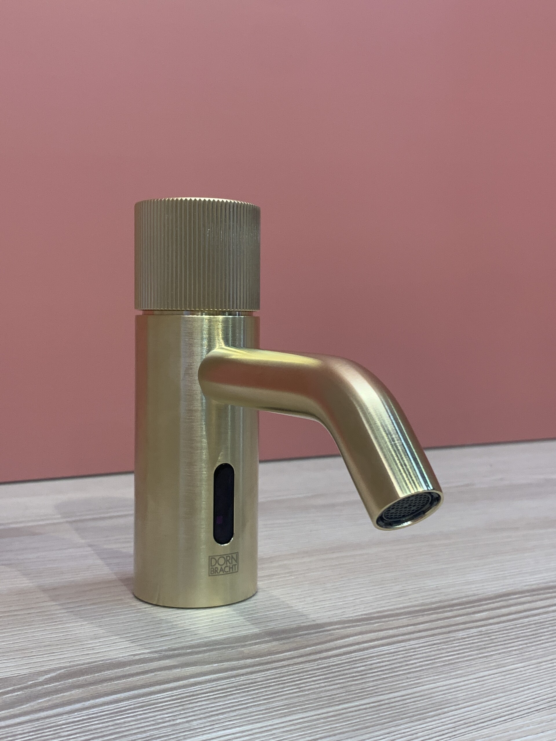 Dornbracht Faucet With Motion For Residential at Salone del Mobile 2022 featuring a gold simple...