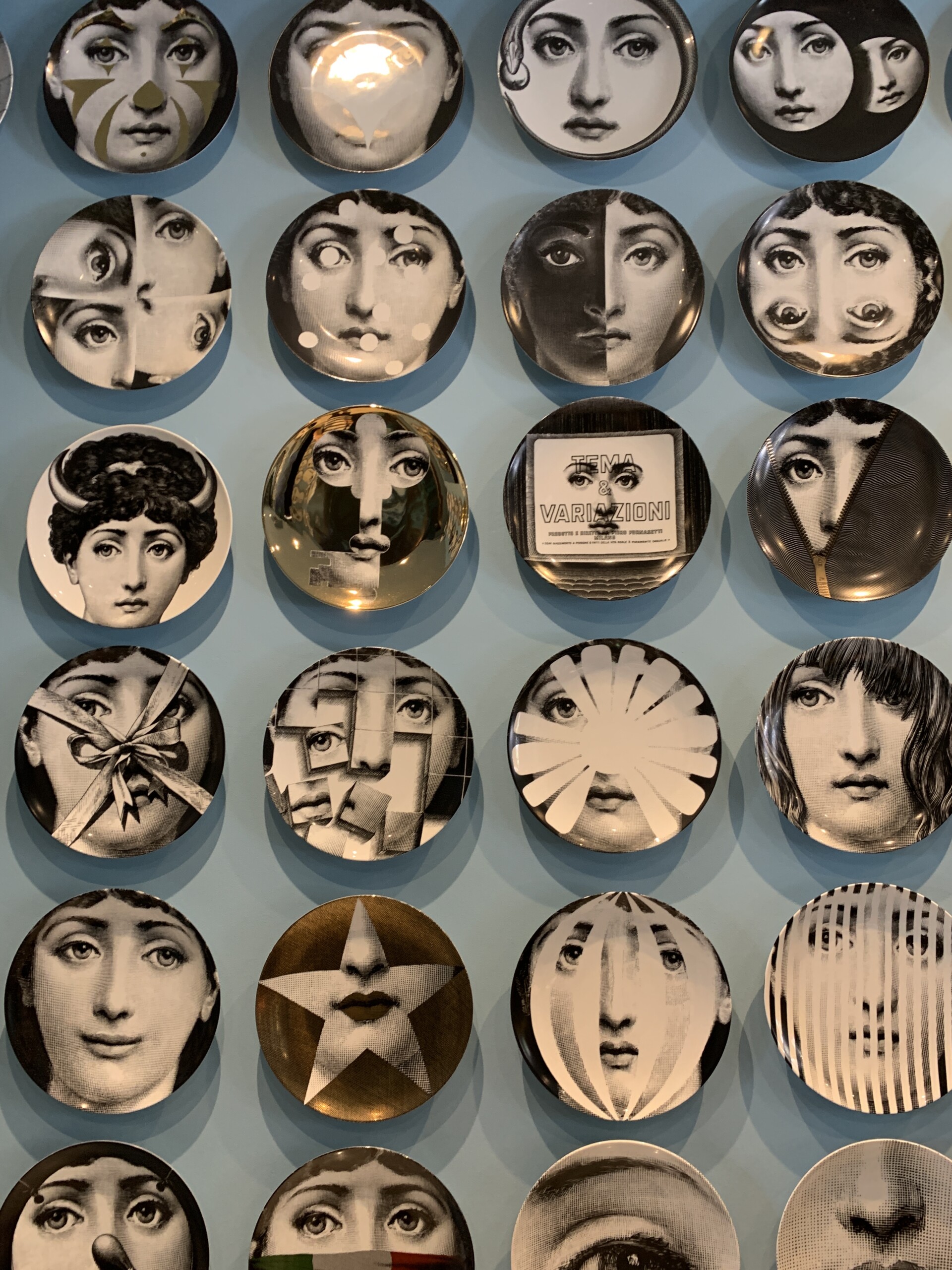 Fornasetti Dishes at Salone del Mobile 2022, featuring faces on plates, eyes everywhere