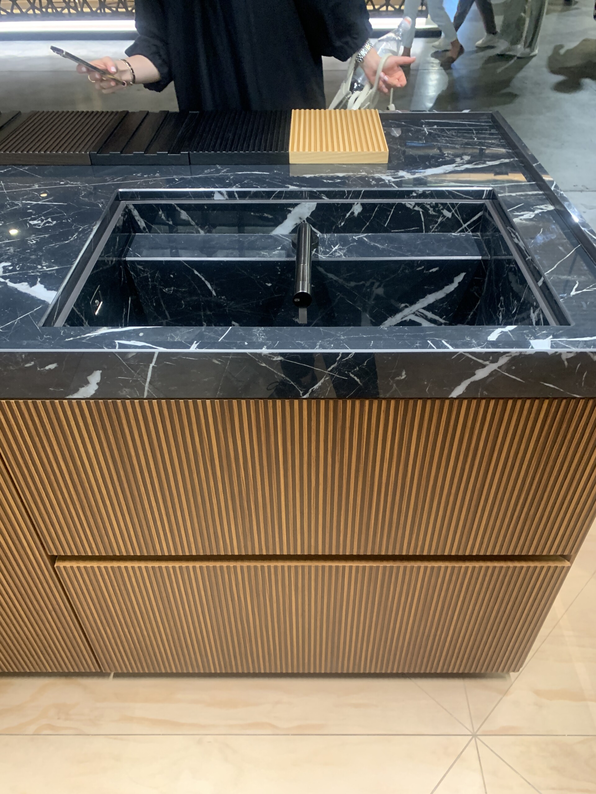 MVK+Italia Fluted Wood Front at Salone del Mobile 2022. Black Marbel with caramel wood.