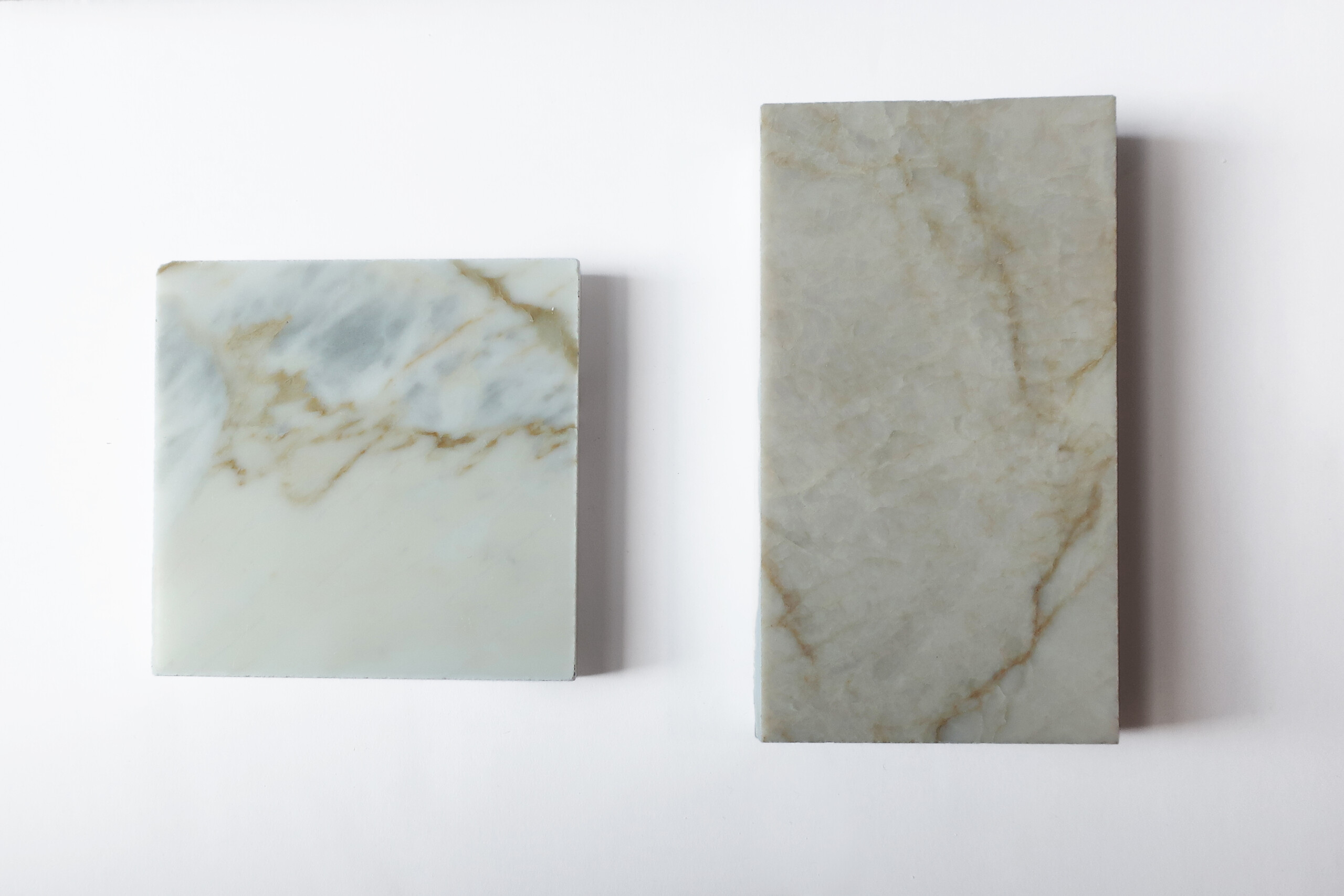 Material samples for interior design: Left - Calacatta Bluette Marble, Right - Taj Mahal Quartzite