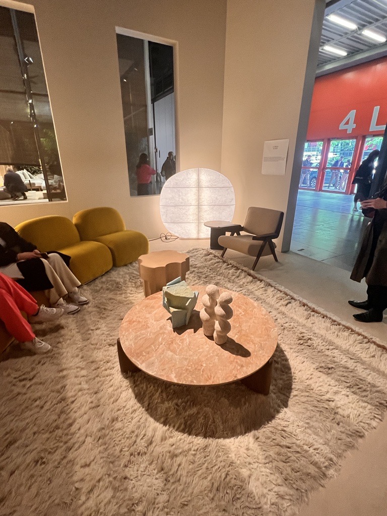 Tacchini showroom, round coffee table, yellow sofa, and paper lantern from Milan Design Week 2023.