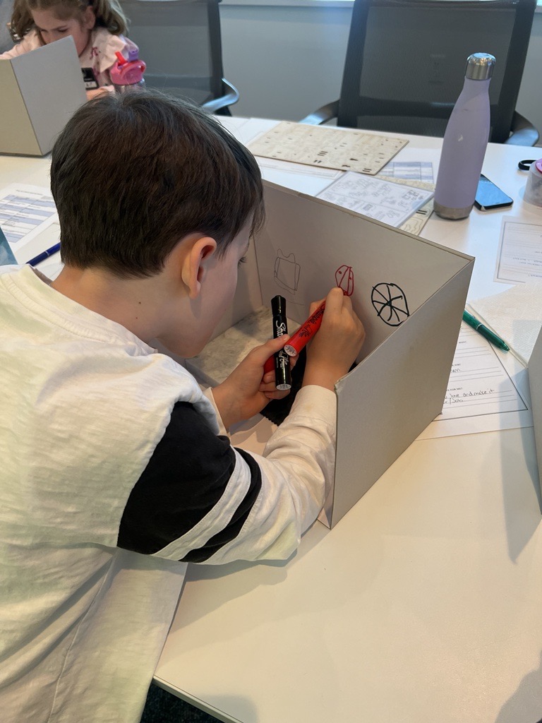 Child building 3-d mockup for Pembrooke & Ives bring your Kid to work