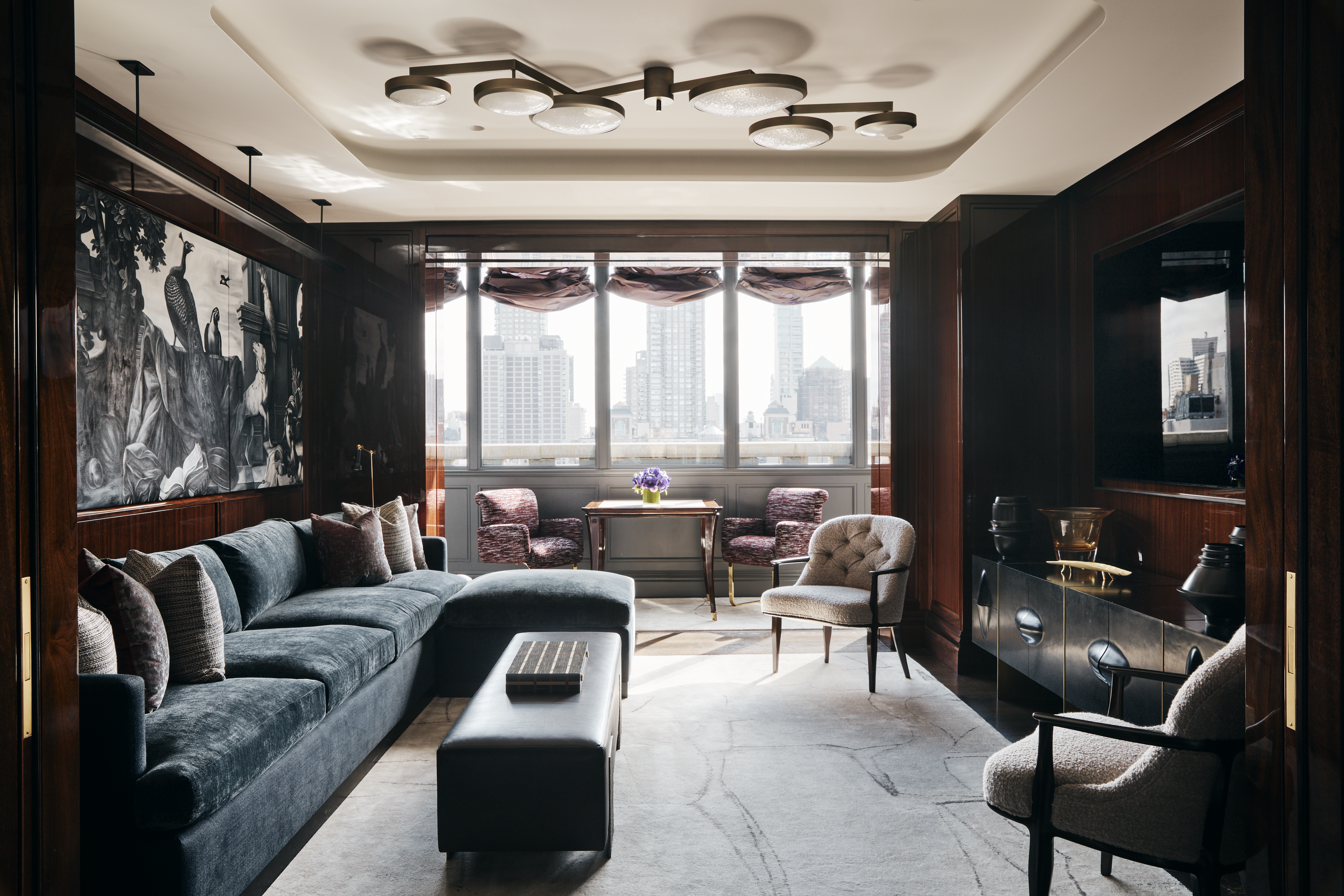 New York City interior design by Pembrooke & Ives. Living room and media zone with glossy wood...