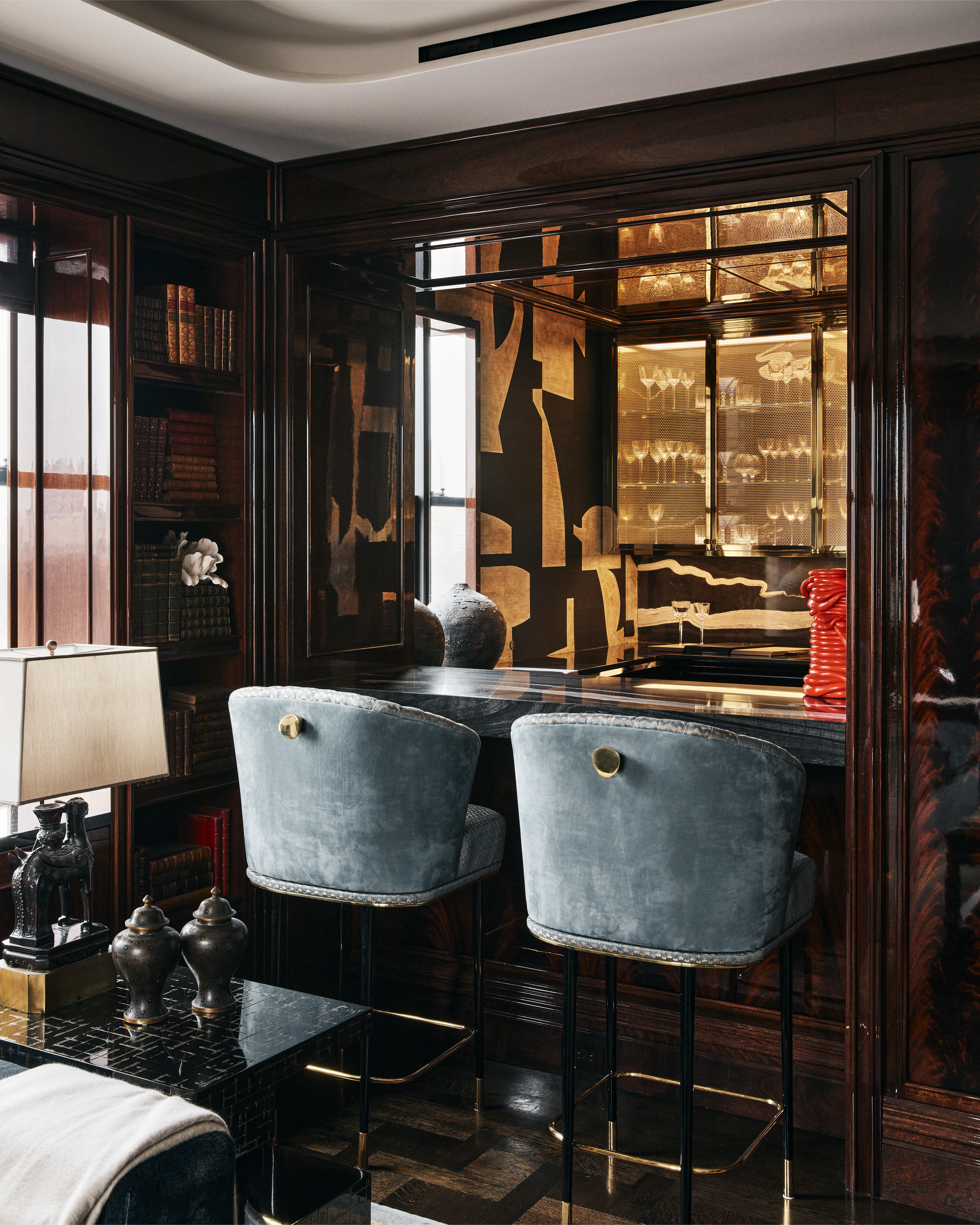 New York City interior design by Pembrooke & Ives. Luxe bar room with wood paneling and custom...