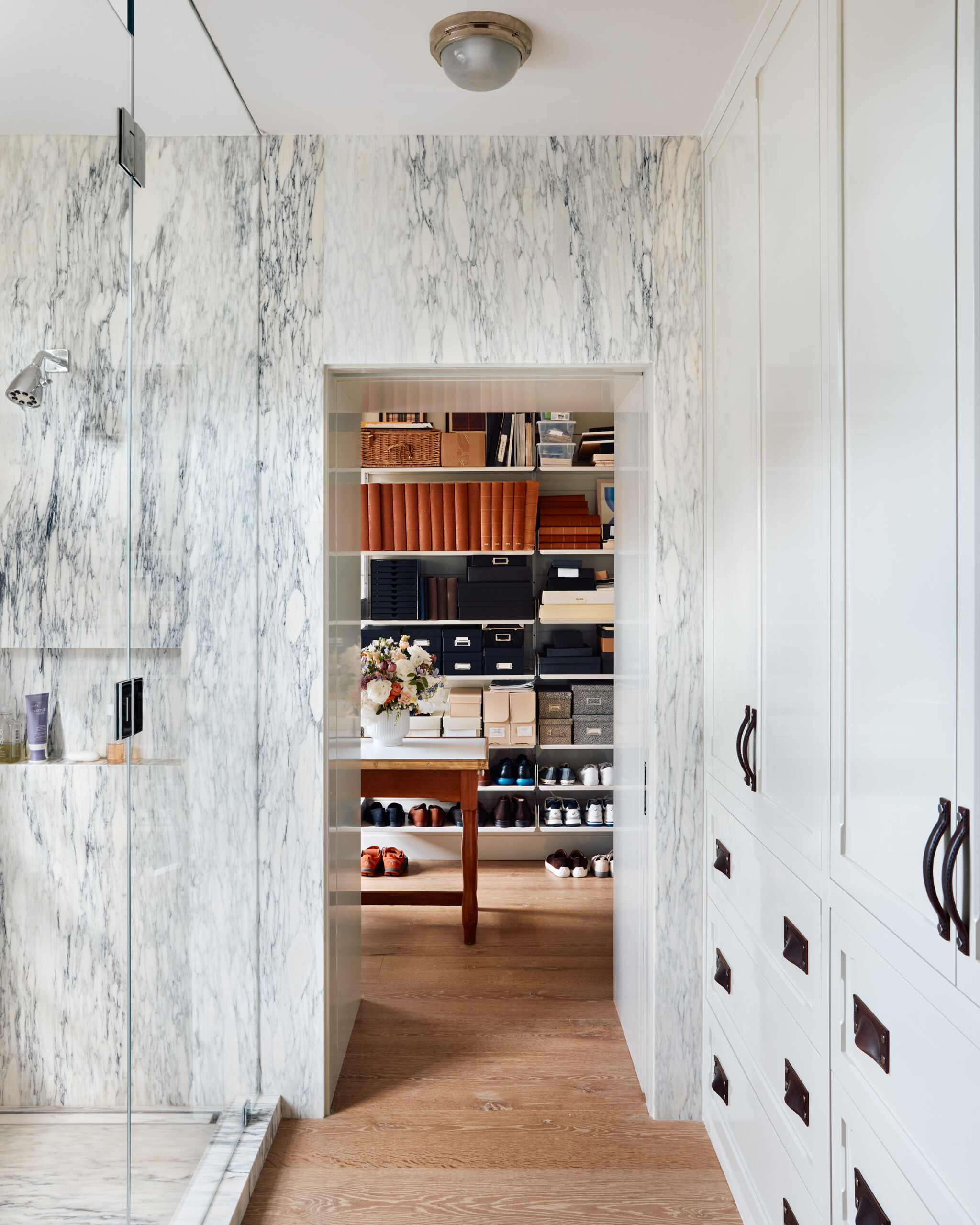 Hamptons Interior Design by Pembrooke & Ives. Primary bathroom with marble shower & accent wall...