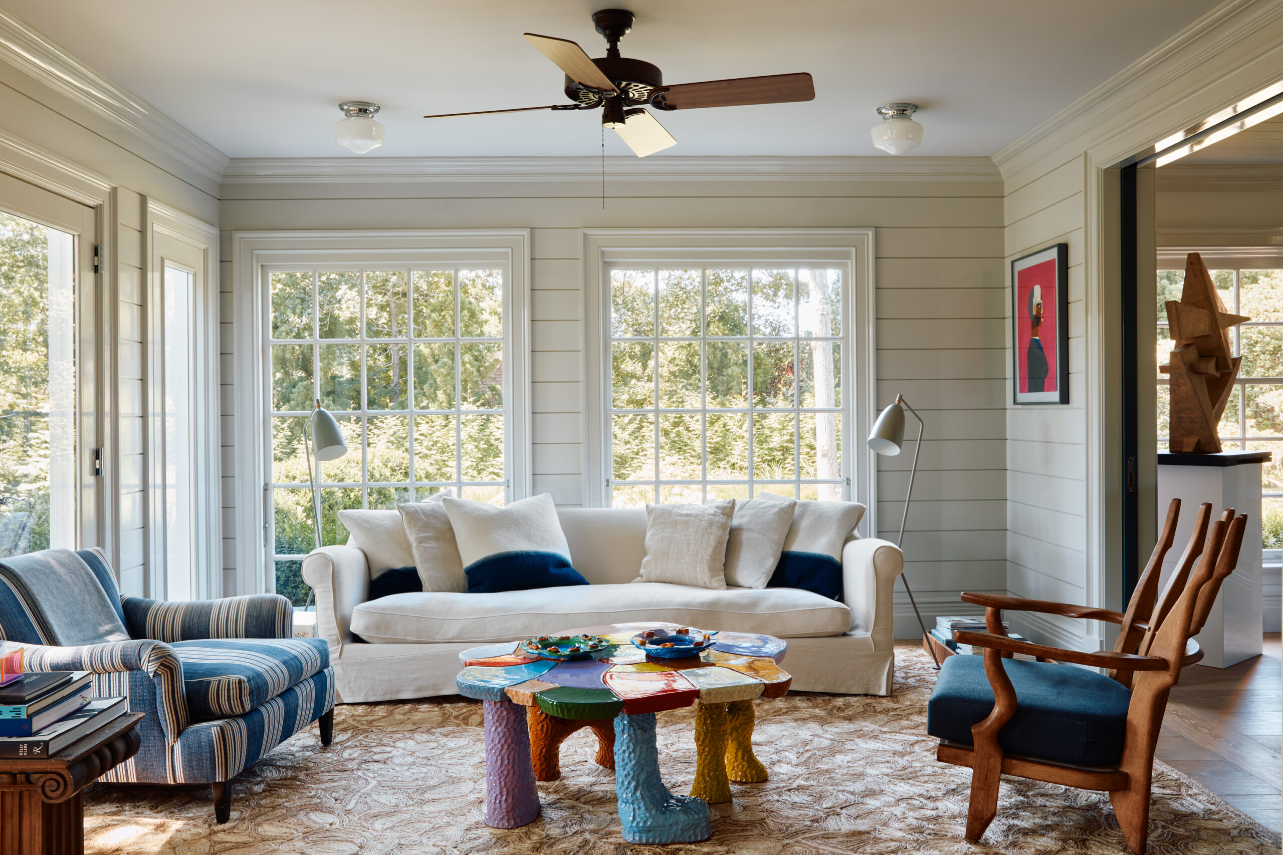 Hamptons Interior Design by Pembrooke & Ives. Sunroom with contemporary coastal furnishings and...