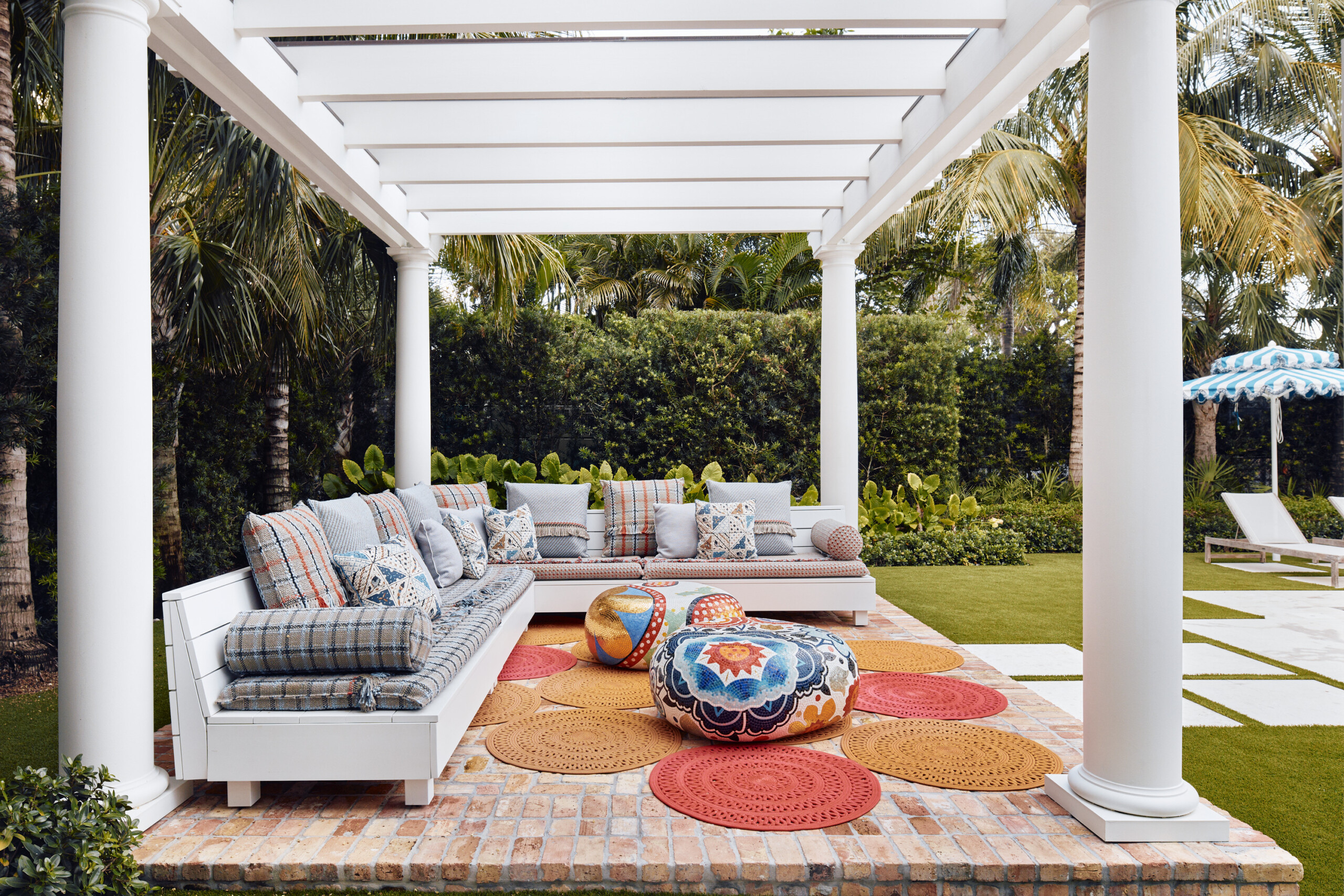 Palm Beach Interior Design by Pembrooke & Ives. Outdoor seating under pergola with upholstered...
