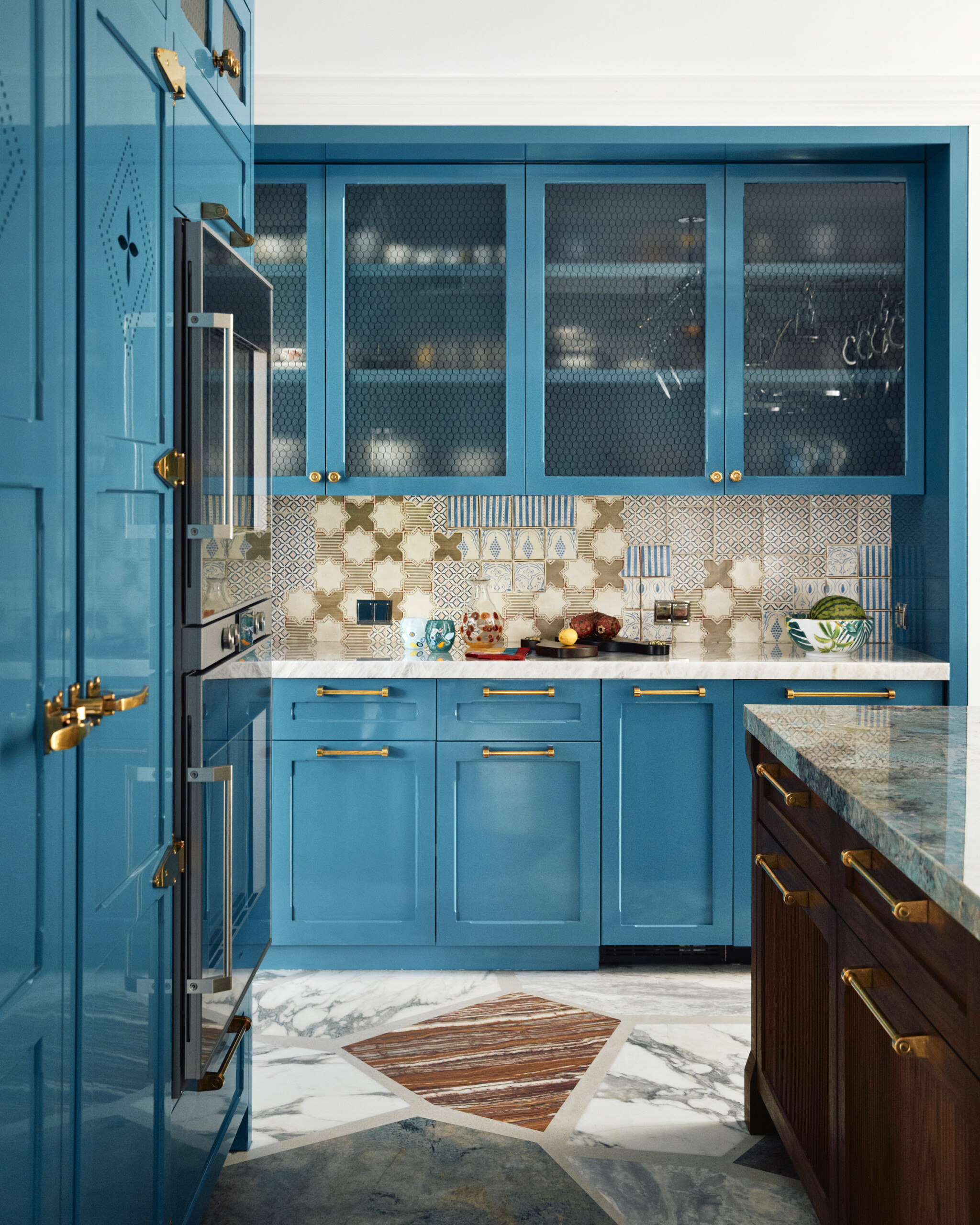 Palm Beach Interior Design by Pembrooke & Ives. Mediterranean inspired kitchen with turquoise millwork,...