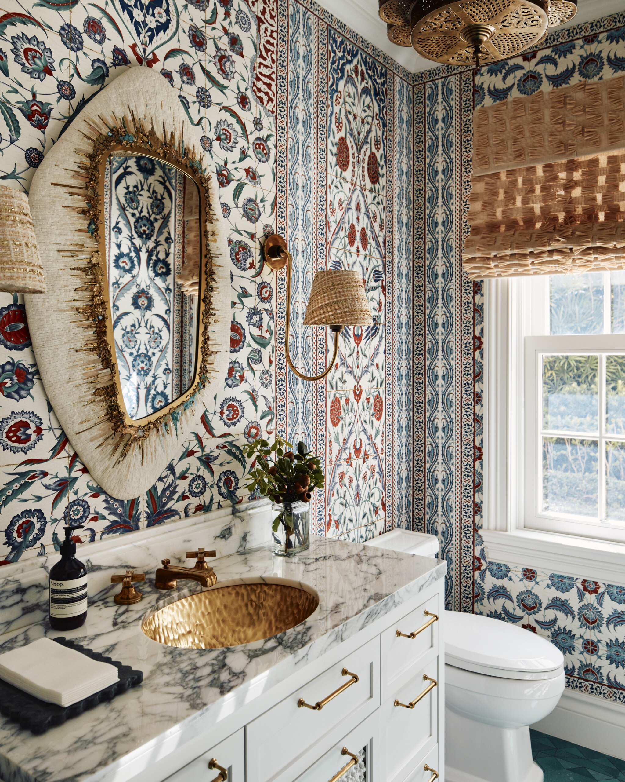 Palm Beach Interior Design by Pembrooke & Ives. Powder Room with patterned wallpaper, marble countertop,...