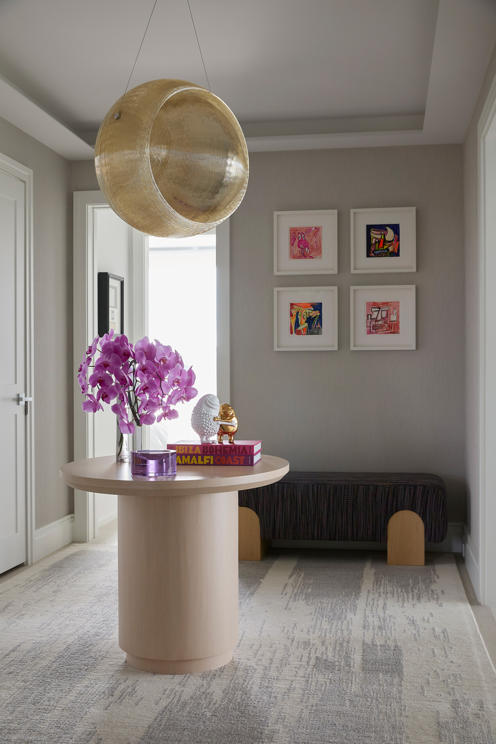 Hamptons Interior Design by Pembrooke & Ives. Gallery hall table with decor, pendant light, and...
