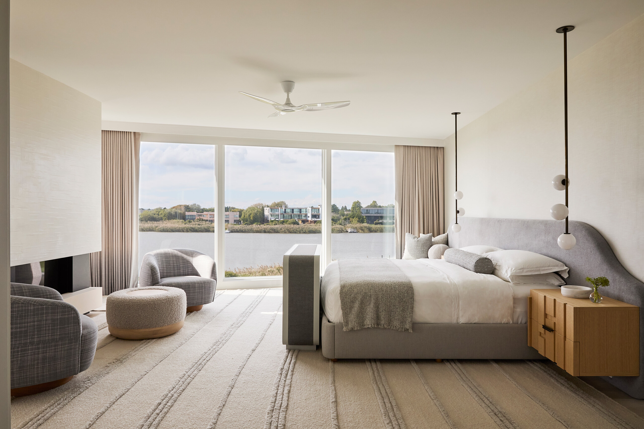 Hamptons Interior Design by Pembrooke & Ives. Primary bedroom with neutral gray palette and custom...