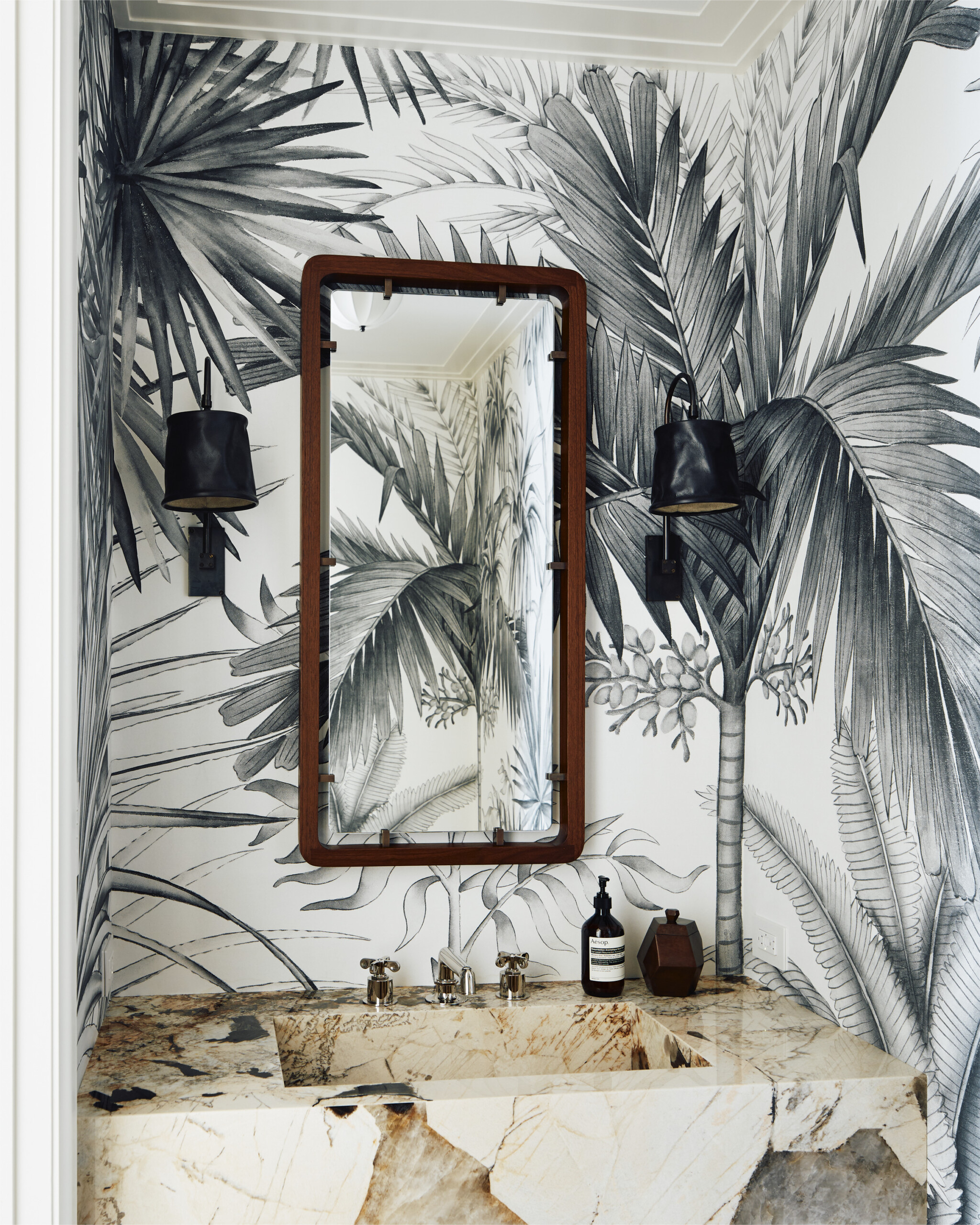 New York City interior design by Pembrooke & Ives. Powder room with palm wallpaper and natural...