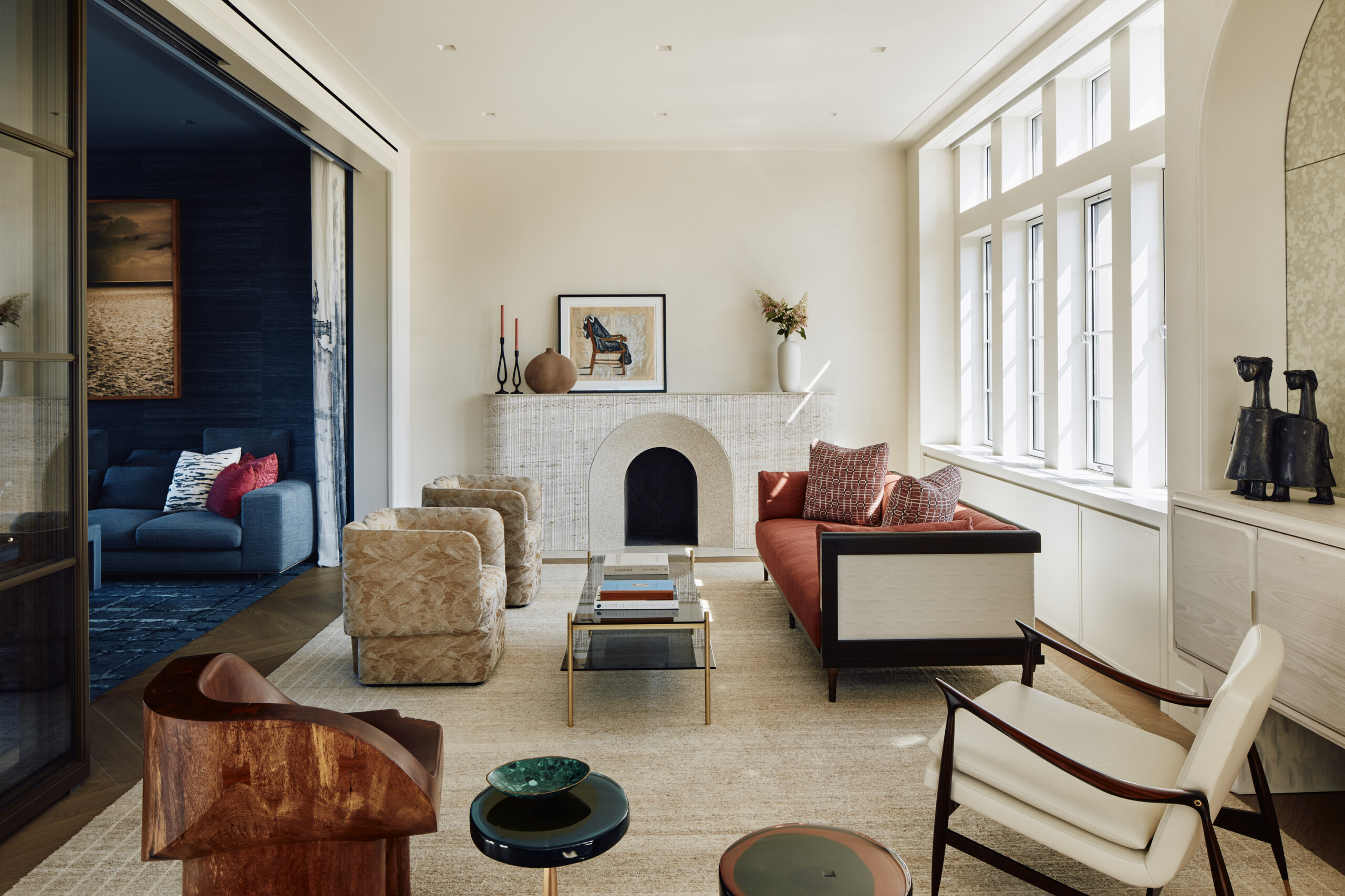 New York City interior design by Pembrooke & Ives. Living room with custom fireplace and neutral...