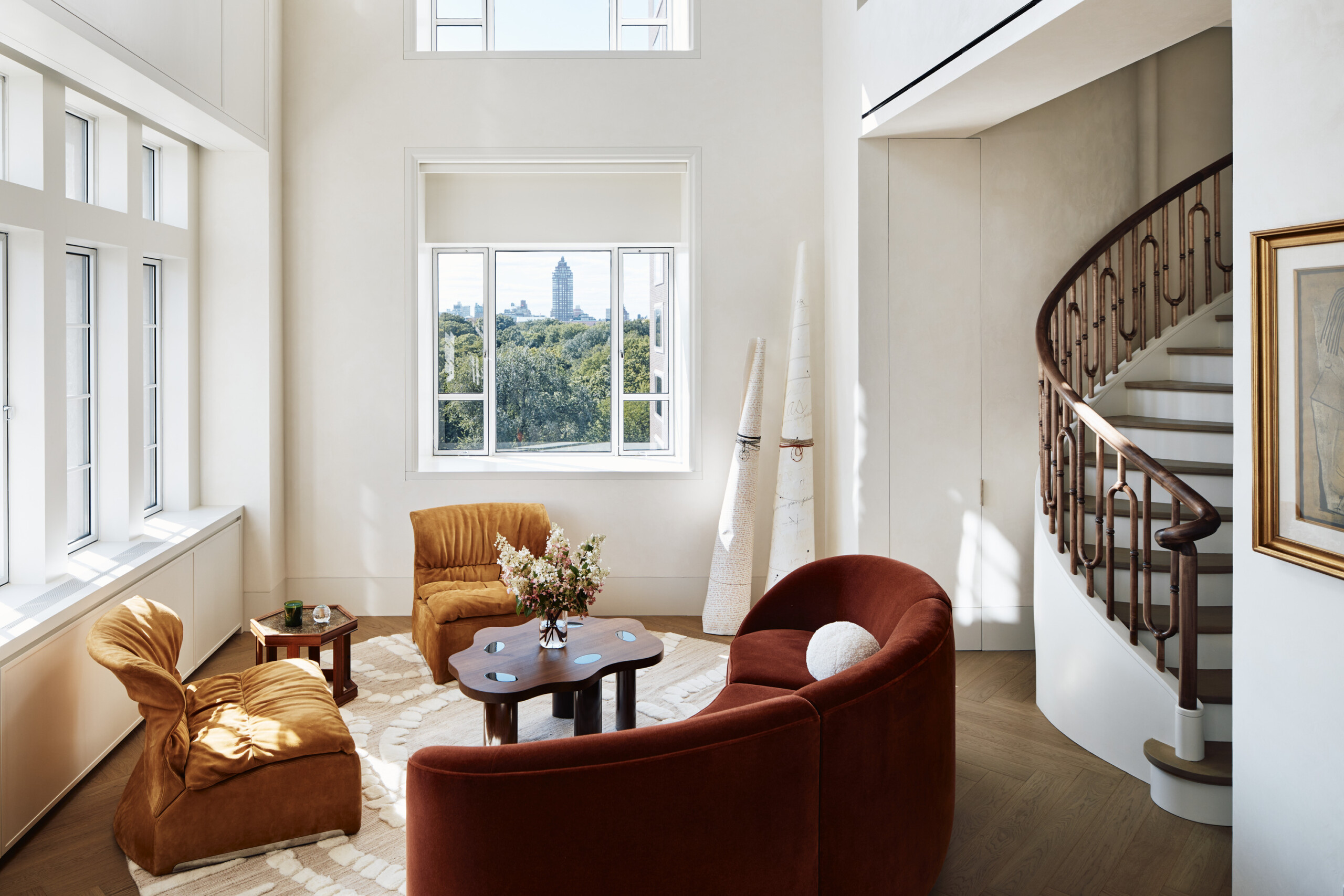 New York City interior design by Pembrooke & Ives. Living room with vibrant furniture and spiral...
