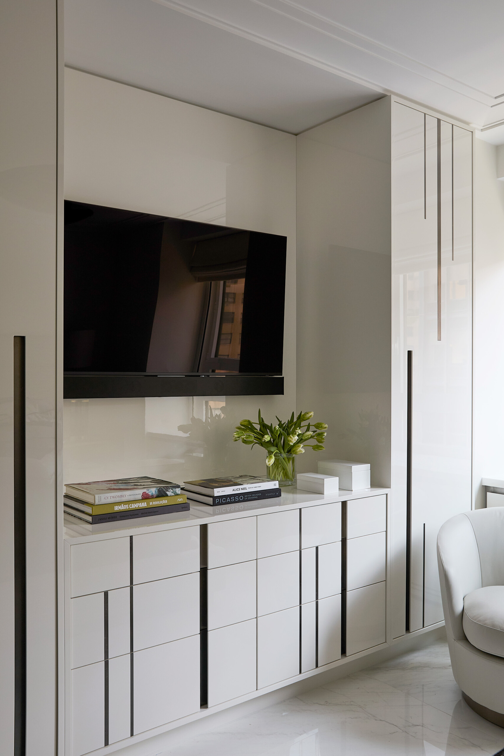 New York City Interior Design by Pembrooke & Ives. Neutral bedroom with glossy millwork storage.