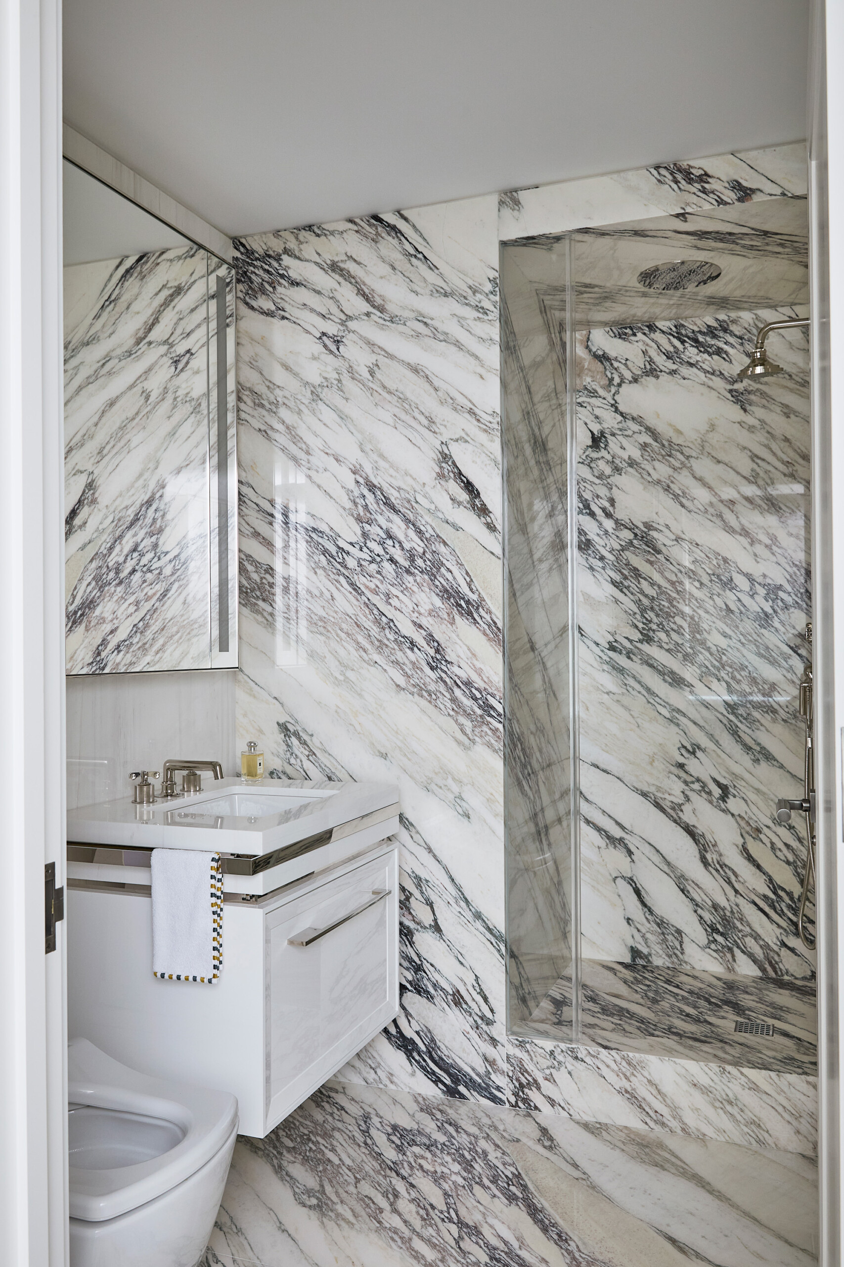 New York City Interior Design by Pembrooke & Ives. Marble bathroom with floating vanity.