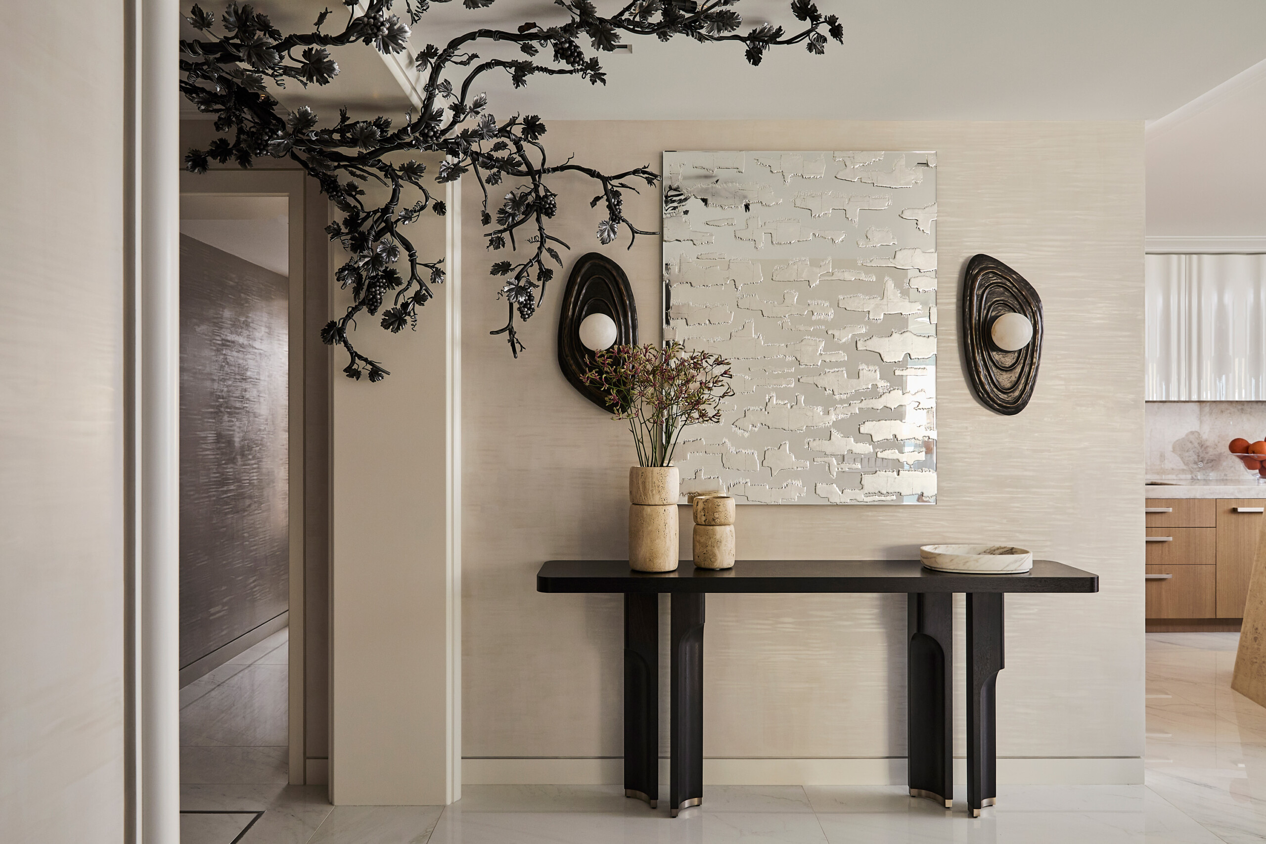 New York City Interior Design by Pembrooke & Ives. Foyer with side table, textured mirror, statement...