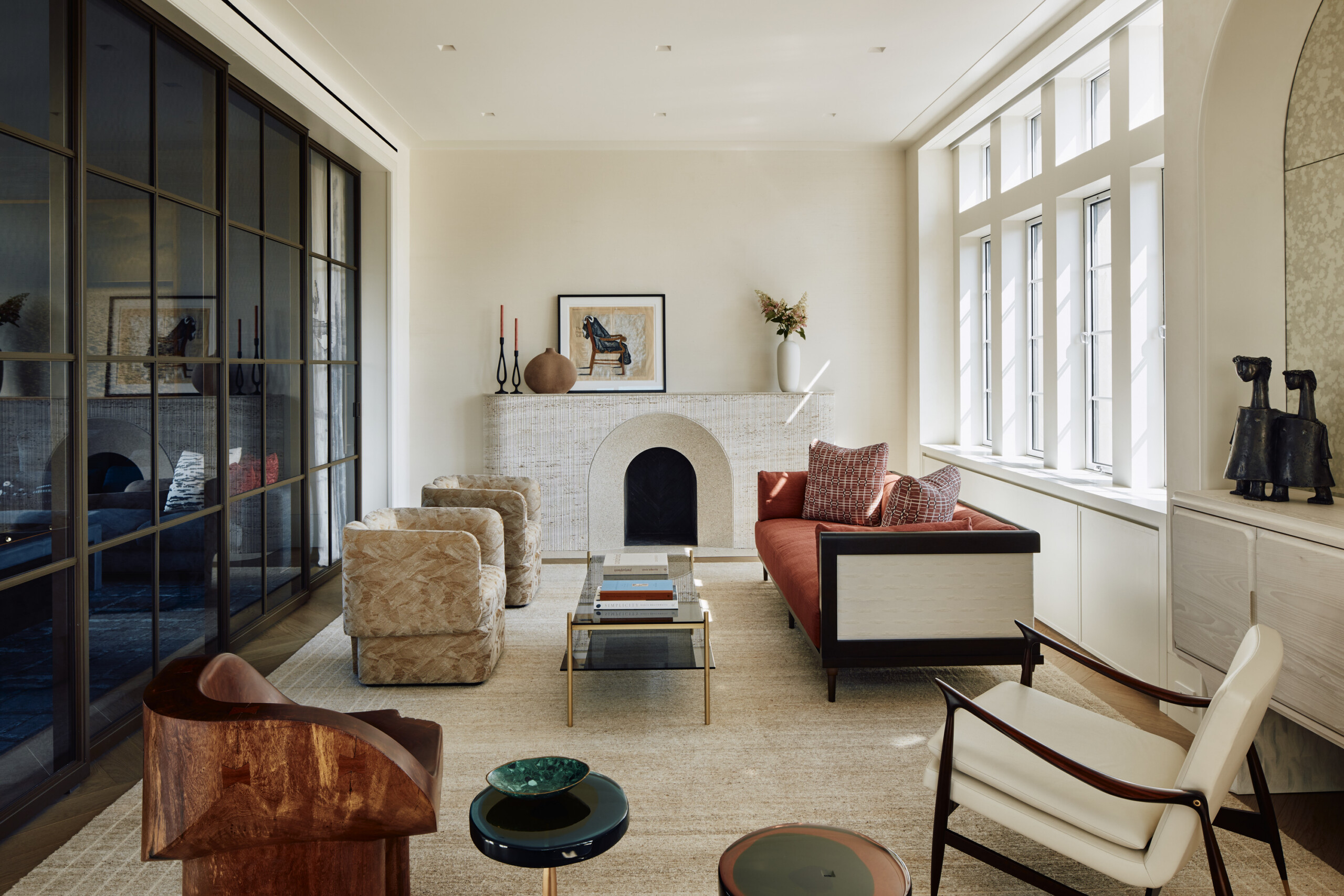 New York City interior design by Pembrooke & Ives. Living room with custom fireplace and neutral...